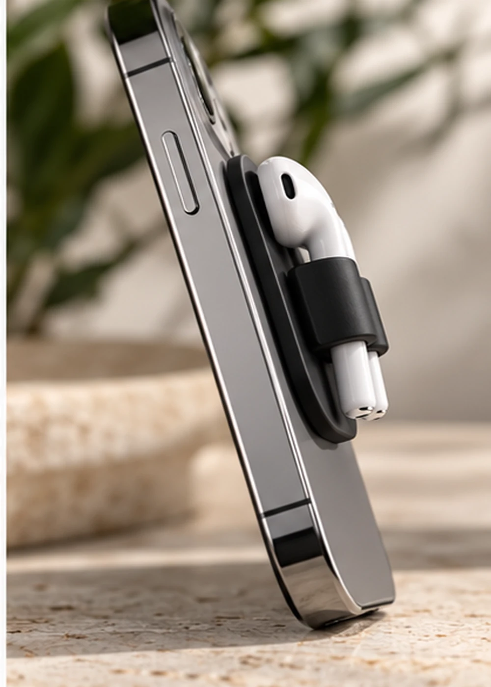 PodMont earbud holder mounted on a phone — conceptual product photograph